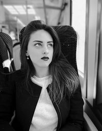 Young woman sitting in train