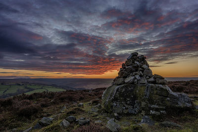 Scenic view of rock formation against sky during sunset