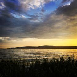 Scenic view of lake against sky during sunset