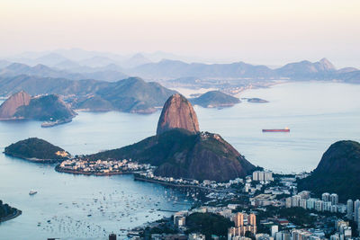 Aerial view of sea and mountains against sky