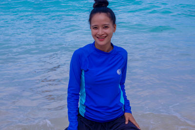 Portrait of boy standing in water