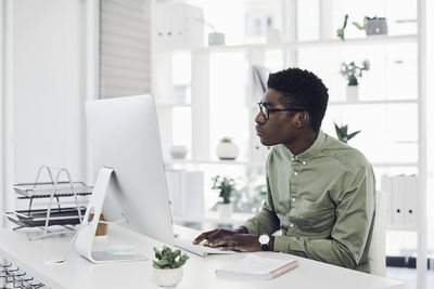 Side view of man working on table