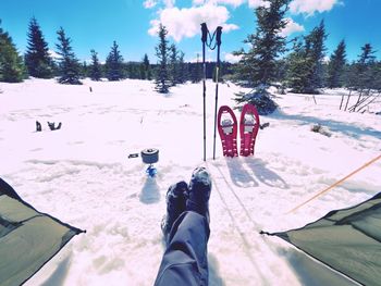 Man relaxing. winter view from camping tent entrance out to snowy landscape. travel lifestyle 