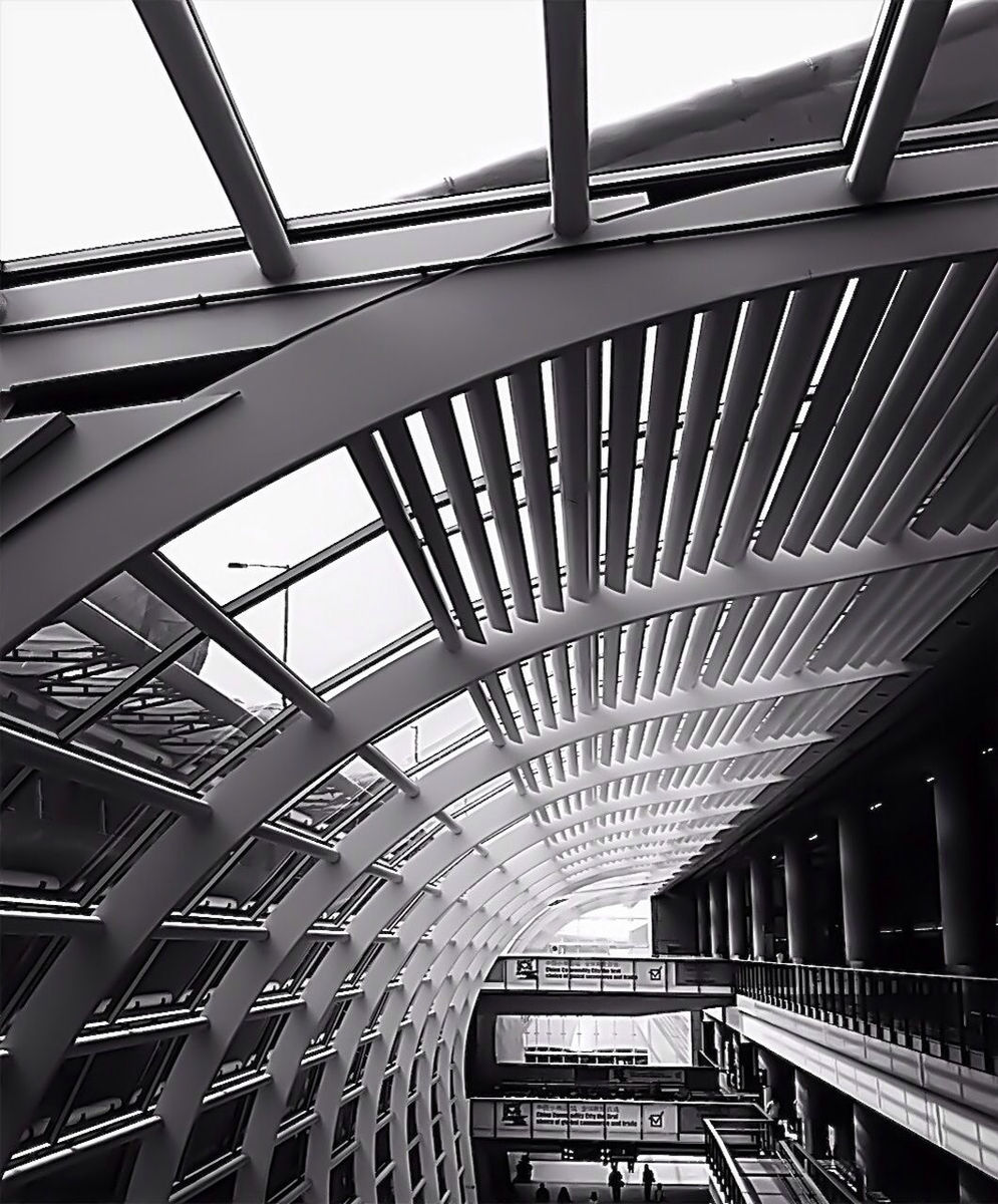 architecture, built structure, low angle view, connection, bridge - man made structure, building exterior, railing, metal, engineering, modern, indoors, sky, building, day, no people, city, metallic, architectural feature, diminishing perspective, pattern