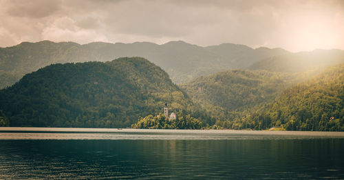 Scenic view of lake and mountains against sky