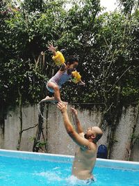 View of shirtless man in swimming pool