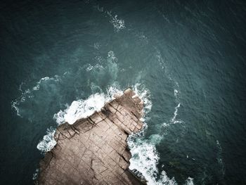 High angle view of rock formation against sea