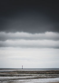 Chauveau lighthouse, isle of re, at low tide on a stormy day. desatured treatment