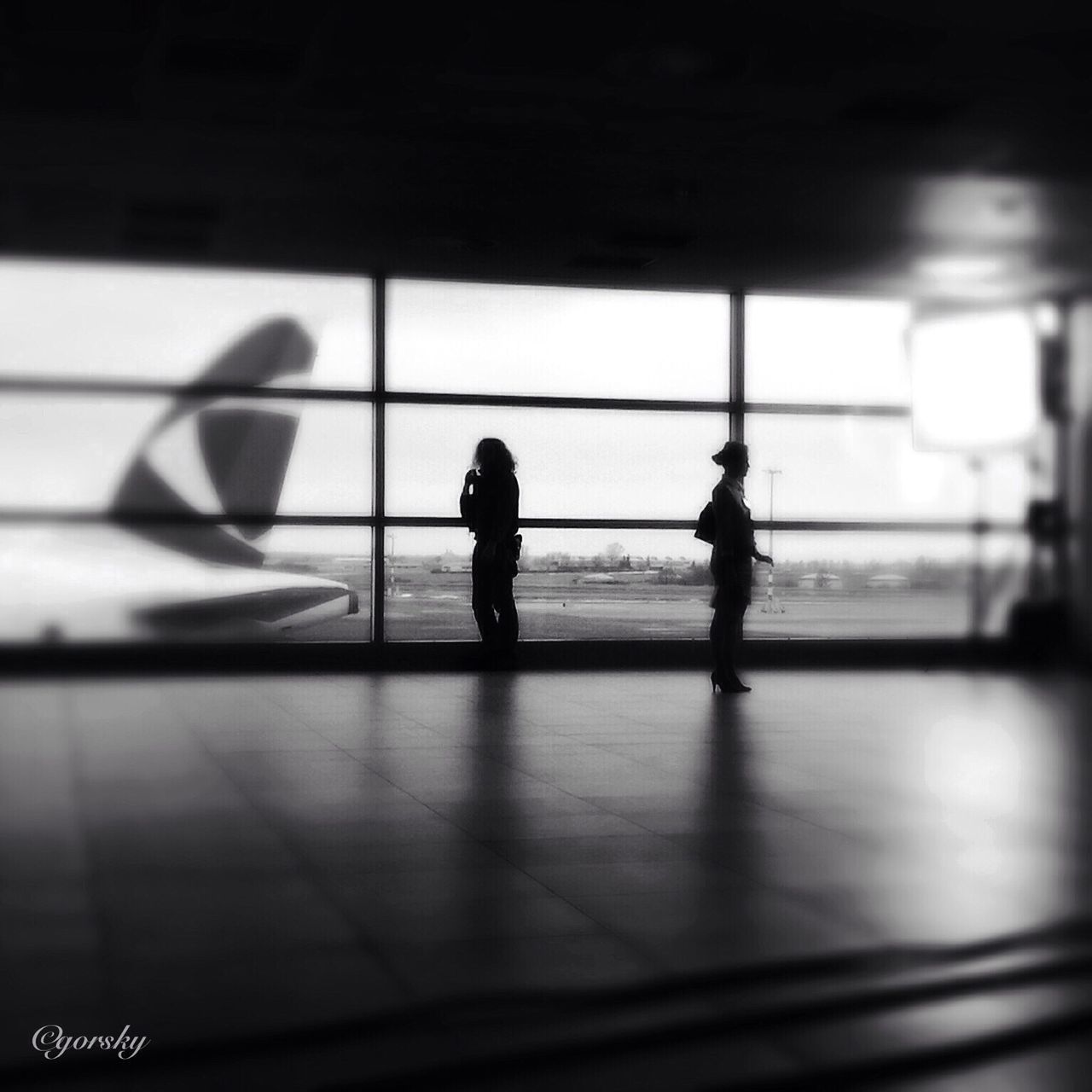 indoors, silhouette, lifestyles, men, shadow, leisure activity, unrecognizable person, walking, window, wall - building feature, person, architecture, full length, built structure, standing, sunlight, selective focus, day