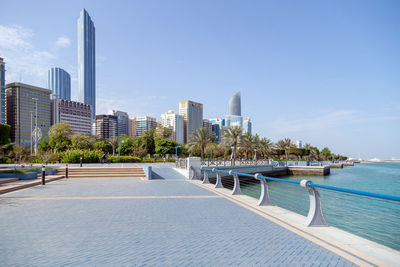 View of swimming pool by buildings against sky