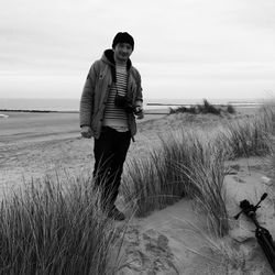 Rear view of woman standing on beach