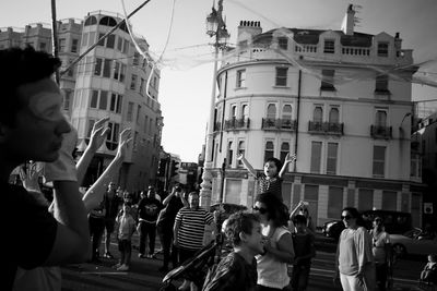 Rear view of people standing in city