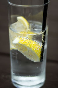 Close-up of lemon in drink on table