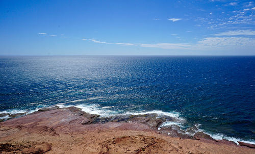 Scenic view of sea against blue sky