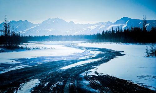 Scenic view of snow covered mountains against sky