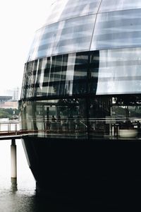 Reflection of building in river against sky