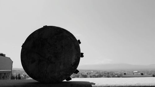 Close-up of rock by sea against clear sky