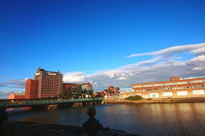 Buildings in city against cloudy sky