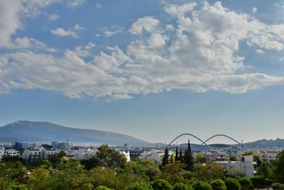 Scenic view of residential district by sea against sky
