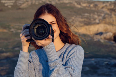 Portrait of woman photographing