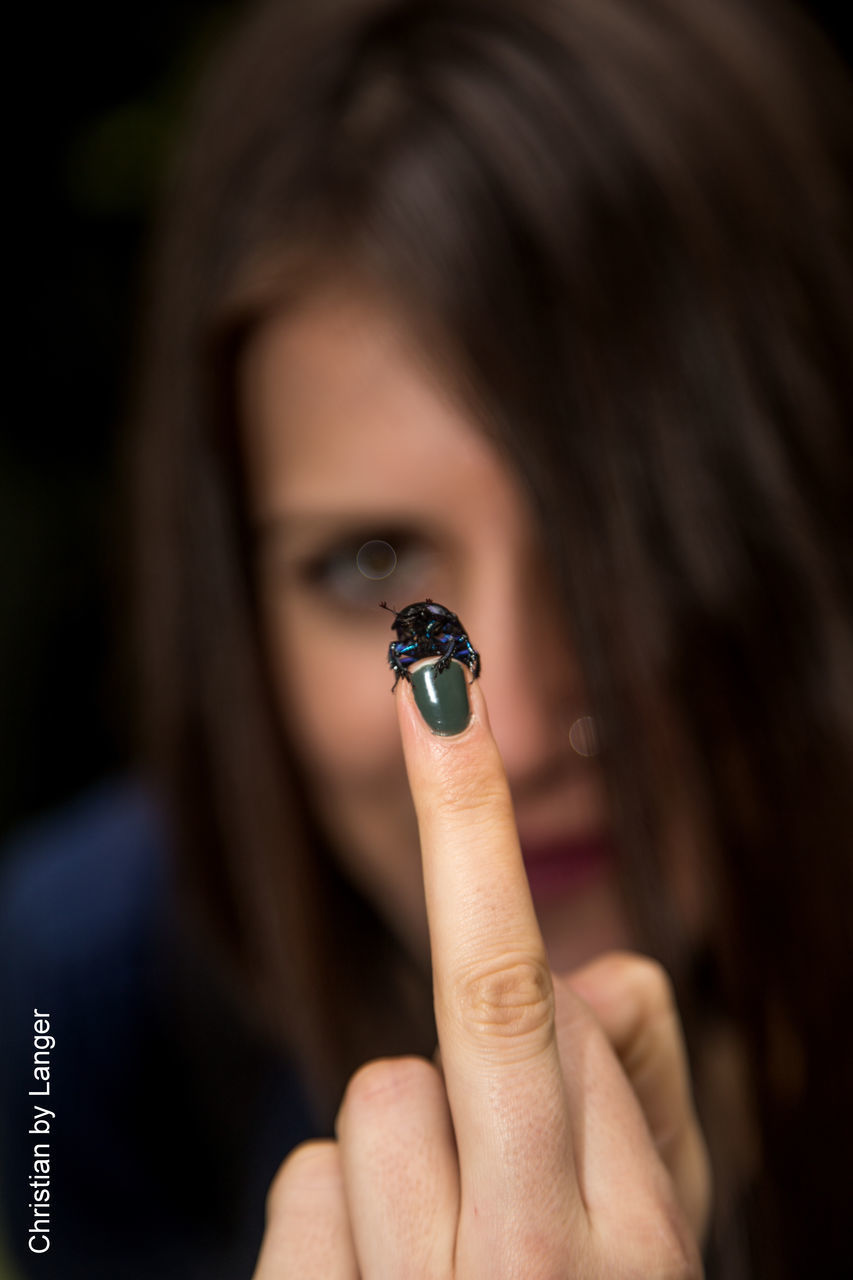 person, holding, human finger, part of, cropped, close-up, lifestyles, leisure activity, focus on foreground, unrecognizable person, indoors, human face, headshot, ring, studio shot, cigarette