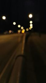 Defocused image of illuminated street lights at night