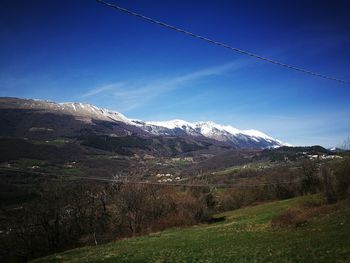 Scenic view of mountains against clear blue sky