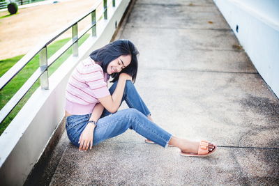 High angle view of woman sitting on staircase