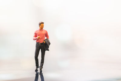 Full length of man standing against blurred background