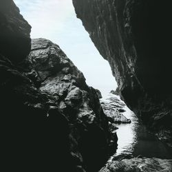 Rock formations by sea against sky