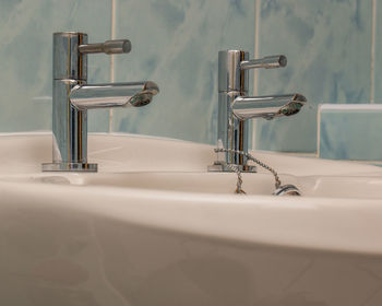 Close-up of faucet in bathroom