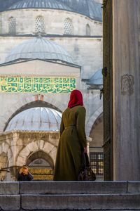 Rear view of two people outside temple