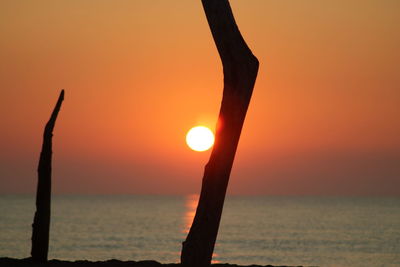 Scenic view of sea against orange sky