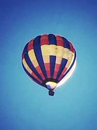 Hot air balloon flying against blue sky