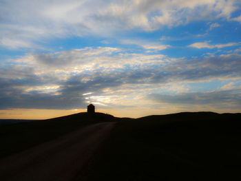 Silhouette landscape against sky during sunset