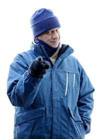 Portrait of man standing against white background