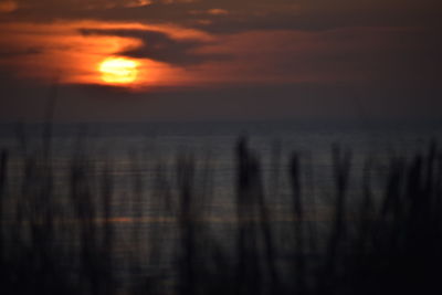 Scenic view of sea against romantic sky at sunset