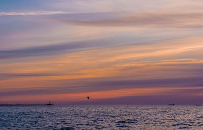 Scenic view of sea against orange sky