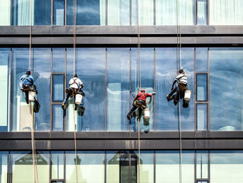 People working in glass building