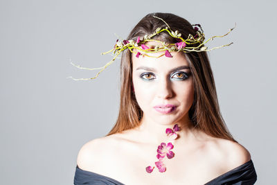 Portrait of beautiful woman against white background