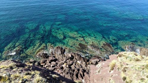 High angle view of rocks in sea