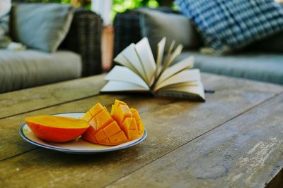 Close-up of mango in plate on table