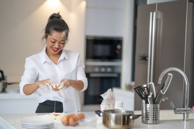 Smiling woman preparing food at home