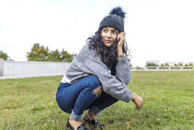 Young woman sitting on field