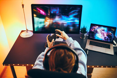 Teenager girl playing video game. playing online tournament. competition and fun. game championship