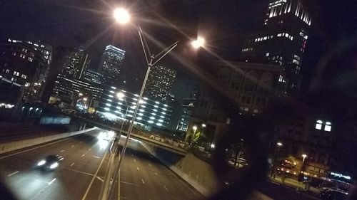 Illuminated city street at night