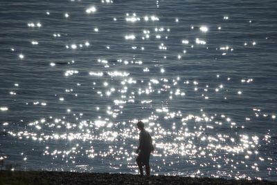 Man standing on beach at night