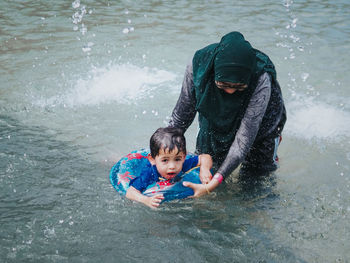 Mother with son in lake