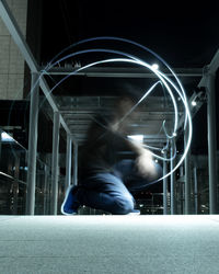 Rear view of man on illuminated city at night