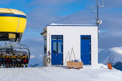 Built structure on snow covered land against sky